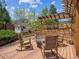 Relaxing outdoor firepit area with comfortable seating and a charming playhouse in the beautifully landscaped yard at 3138 E Otero Cir, Centennial, CO 80122