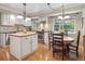 Well-lit kitchen area featuring white cabinets and an island with butcher block countertop, adjoining breakfast nook at 3138 E Otero Cir, Centennial, CO 80122
