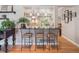 Open kitchen view with bar seating, pendant lighting, and decorative plants at 3138 E Otero Cir, Centennial, CO 80122