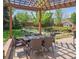 Charming outdoor dining area with a pergola, perfect for al fresco meals and enjoying the landscaped backyard at 3138 E Otero Cir, Centennial, CO 80122