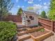 Charming playhouse nestled in a beautifully landscaped yard with raised garden beds and wooden steps at 3138 E Otero Cir, Centennial, CO 80122