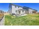 The backyard offers a patio and lawn area, perfect for relaxing and entertaining friends and Gathering at 45840 Laceleaf Dr, Bennett, CO 80102