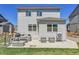 The backyard offers a great space for outdoor living with patio furniture and a place for games at 45840 Laceleaf Dr, Bennett, CO 80102