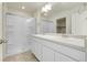 Bright bathroom features double sinks and a walk-in shower with glass doors at 45840 Laceleaf Dr, Bennett, CO 80102