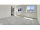 This bedroom boasts two windows for lots of light and plush gray carpet at 45840 Laceleaf Dr, Bennett, CO 80102