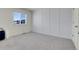 This bedroom boasts a large window and plush gray carpeting at 45840 Laceleaf Dr, Bennett, CO 80102