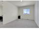 This bedroom boasts a large window and plush gray carpeting at 45840 Laceleaf Dr, Bennett, CO 80102