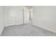 This bedroom boasts plush gray carpeting and dual closets at 45840 Laceleaf Dr, Bennett, CO 80102