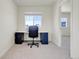 Bright bedroom features a work space with a desk and plush gray carpet at 45840 Laceleaf Dr, Bennett, CO 80102