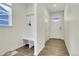 Bright entryway with a built-in hall tree and durable, stylish wood floors at 45840 Laceleaf Dr, Bennett, CO 80102