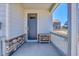 Inviting front porch with stone accents and a charming bench, perfect for relaxing at 45840 Laceleaf Dr, Bennett, CO 80102