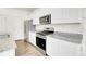 Kitchen featuring granite countertops, stainless steel appliances and wooden floor at 45840 Laceleaf Dr, Bennett, CO 80102