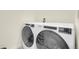 This laundry room features modern appliances with digital controls and space for detergents at 45840 Laceleaf Dr, Bennett, CO 80102