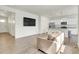 Bright open-concept living room and kitchen with modern appliances and granite countertops at 45840 Laceleaf Dr, Bennett, CO 80102
