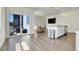 Open-concept living area with access to a patio and modern kitchen at 45840 Laceleaf Dr, Bennett, CO 80102