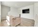 Comfortable living room with a large TV and easy access to the stairway at 45840 Laceleaf Dr, Bennett, CO 80102