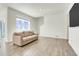 Spacious living room with large window providing natural light and comfortable seating at 45840 Laceleaf Dr, Bennett, CO 80102