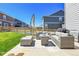 Relaxing outdoor patio with comfortable seating, a fire pit, and an umbrella to provide shade at 45840 Laceleaf Dr, Bennett, CO 80102