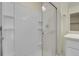 Walk-in shower features glass doors and built-in shelving at 45840 Laceleaf Dr, Bennett, CO 80102
