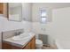 Bright bathroom featuring a classic sink and fixtures, and tiled tub-shower at 275 Pontiac St, Denver, CO 80220