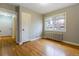 This light-filled bedroom features hardwood floors, a radiator, and a window for natural light at 275 Pontiac St, Denver, CO 80220
