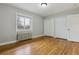Bedroom featuring hardwood floors, closet, radiator, and window for natural light at 275 Pontiac St, Denver, CO 80220