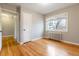 This light-filled bedroom features hardwood floors, a radiator, and a window for natural light at 275 Pontiac St, Denver, CO 80220