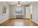 Large bedroom with hardwood floors, radiator, closet, and natural light from two windows at 275 Pontiac St, Denver, CO 80220