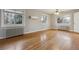 Spacious bedroom with hardwood floors, multiple windows, and a vintage ceiling fan at 275 Pontiac St, Denver, CO 80220