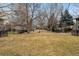 Sprawling green common area lined with mature trees and fenced yards, perfect for community enjoyment and recreation at 275 Pontiac St, Denver, CO 80220