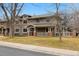 Charming multi-story home featuring a covered porch, well-maintained lawn, and inviting curb appeal at 275 Pontiac St, Denver, CO 80220