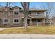 Charming home facade with a welcoming porch, showcasing classic design elements and curb appeal, lush landscape, and mature trees at 275 Pontiac St, Denver, CO 80220