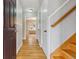 Bright hallway featuring hardwood floors, classic trim, and a staircase leading to the upper level at 275 Pontiac St, Denver, CO 80220