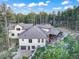 Aerial view of the home's exterior, showing the backyard, patio, surrounding trees and driveway at 18330 Archers Dr, Monument, CO 80132