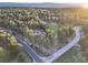 Scenic aerial view of a property surrounded by lush greenery and winding roads, offering a sense of peaceful seclusion at 18330 Archers Dr, Monument, CO 80132