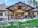 Spacious covered back patio featuring outdoor seating, a built-in grill, and floor-to-ceiling sliding doors at 18330 Archers Dr, Monument, CO 80132