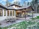 Spacious back patio that includes outdoor seating, an exterior fireplace, and a well-kept yard at 18330 Archers Dr, Monument, CO 80132