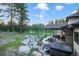 Landscaped backyard with a covered patio, stone retaining wall and potential for outdoor entertaining near greenbelt and hot tub at 18330 Archers Dr, Monument, CO 80132