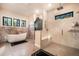 Bright bathroom with a soaking tub, walk-in shower, and views of the outside at 18330 Archers Dr, Monument, CO 80132