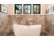 Modern bathroom featuring a standalone tub and black-trimmed windows at 18330 Archers Dr, Monument, CO 80132