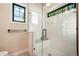 Beautiful bathroom featuring a glass shower, white subway tile, black hardware and a window offering ample natural light at 18330 Archers Dr, Monument, CO 80132