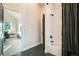 Bathroom featuring a tub with a shower and a view into the adjacent living room at 18330 Archers Dr, Monument, CO 80132