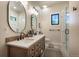Bright, modern bathroom featuring dual sinks, wooden vanity, and a glass shower enclosure at 18330 Archers Dr, Monument, CO 80132