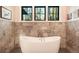 Spa-like bathroom features a freestanding tub with elegant fixtures and marble accent walls at 18330 Archers Dr, Monument, CO 80132