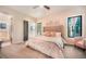 Inviting bedroom with a plush bed, floral decor, and abundant natural light at 18330 Archers Dr, Monument, CO 80132