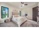 Bright and airy bedroom with a tufted headboard, plush carpeting, and a picturesque view from the large window at 18330 Archers Dr, Monument, CO 80132