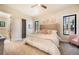 Comfortable bedroom with neutral tones and natural light from black frame windows at 18330 Archers Dr, Monument, CO 80132