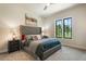 Relaxing bedroom with a tufted headboard, plush bedding, and a large window at 18330 Archers Dr, Monument, CO 80132