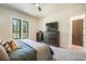 Stylish bedroom featuring large windows with nature views and soft bedding at 18330 Archers Dr, Monument, CO 80132