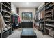 Spacious walk-in closet with custom shelving, drawers, and center island for optimal storage at 18330 Archers Dr, Monument, CO 80132